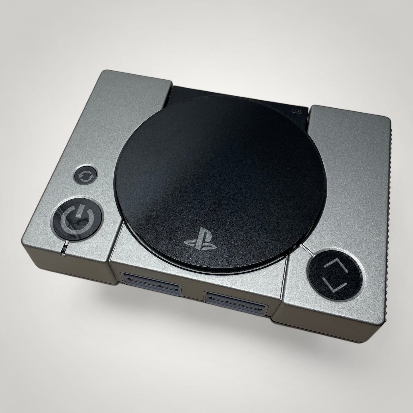 StudioFR custom black and grey PlayStation 1 console with engraved buttons and RGB lighting. One-of-one build.