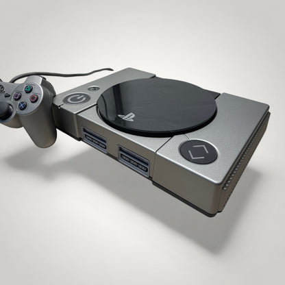 StudioFR custom black and grey PlayStation 1 console with matching controller and engraved buttons. Features RGB lighting.