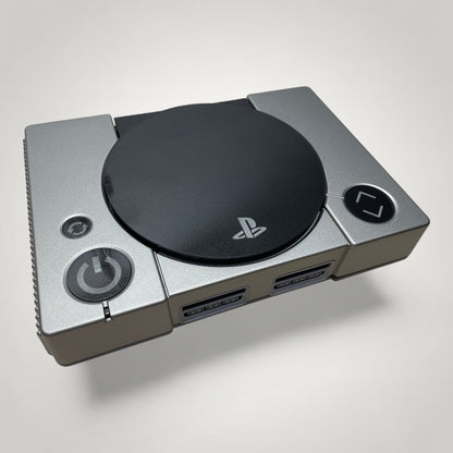 StudioFR custom black and grey PlayStation 1 console with engraved logo and buttons, RGB lighting.