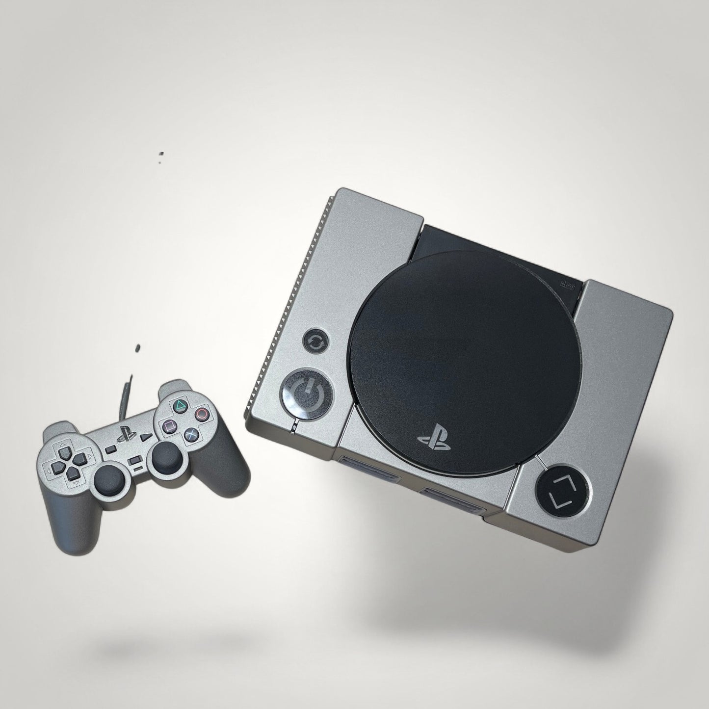 StudioFR custom black and grey PlayStation 1 console with matching controller. Features engraved logo and buttons, RGB lighting.