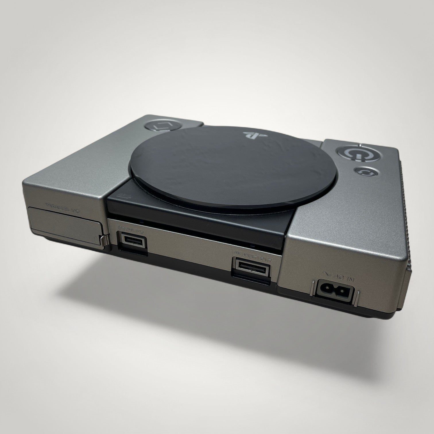 StudioFR customized black and grey PlayStation 1 console with engraved logo and buttons, and RGB lighting.