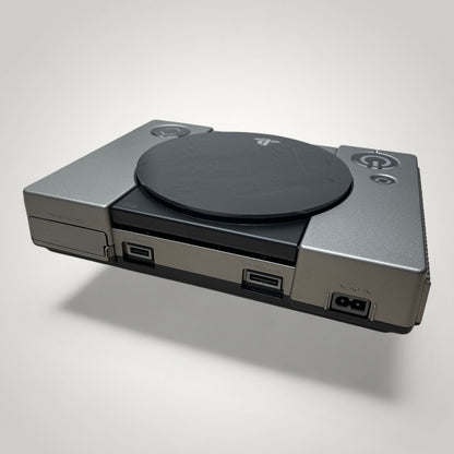 StudioFR customized black and grey PlayStation 1 console with engraved logo and buttons, and RGB lighting.