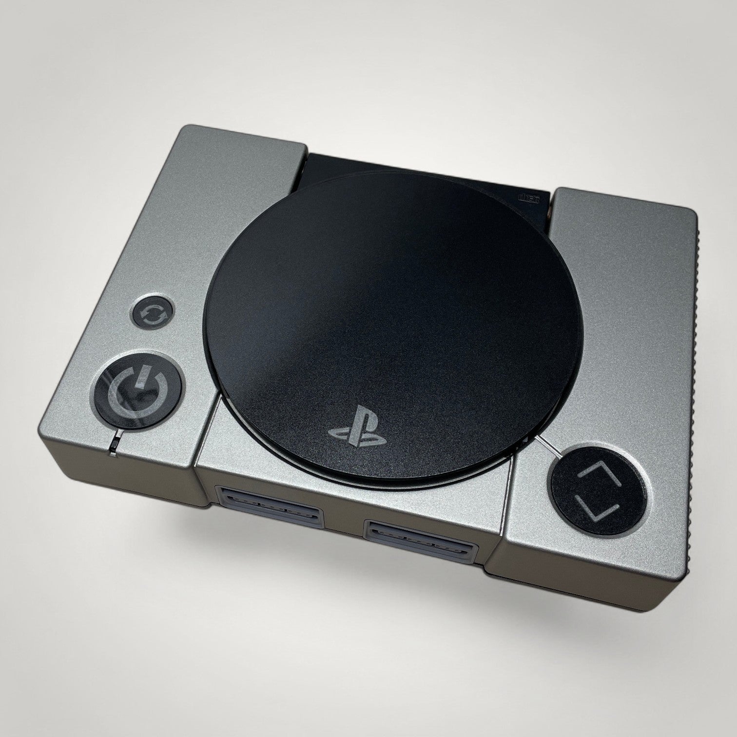 StudioFR custom black and grey PlayStation 1 console with engraved buttons and RGB lighting. One-of-one build.