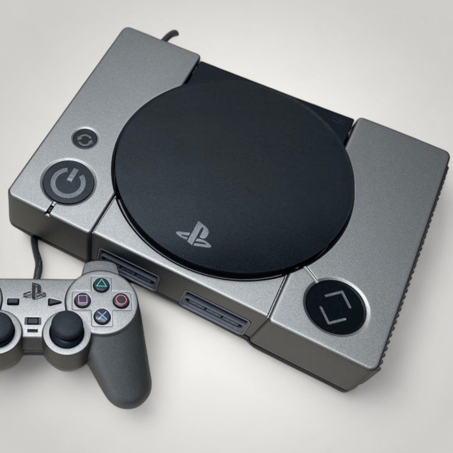 StudioFR custom black and grey PlayStation 1 console with matching controller. Features engraved logo and buttons.
