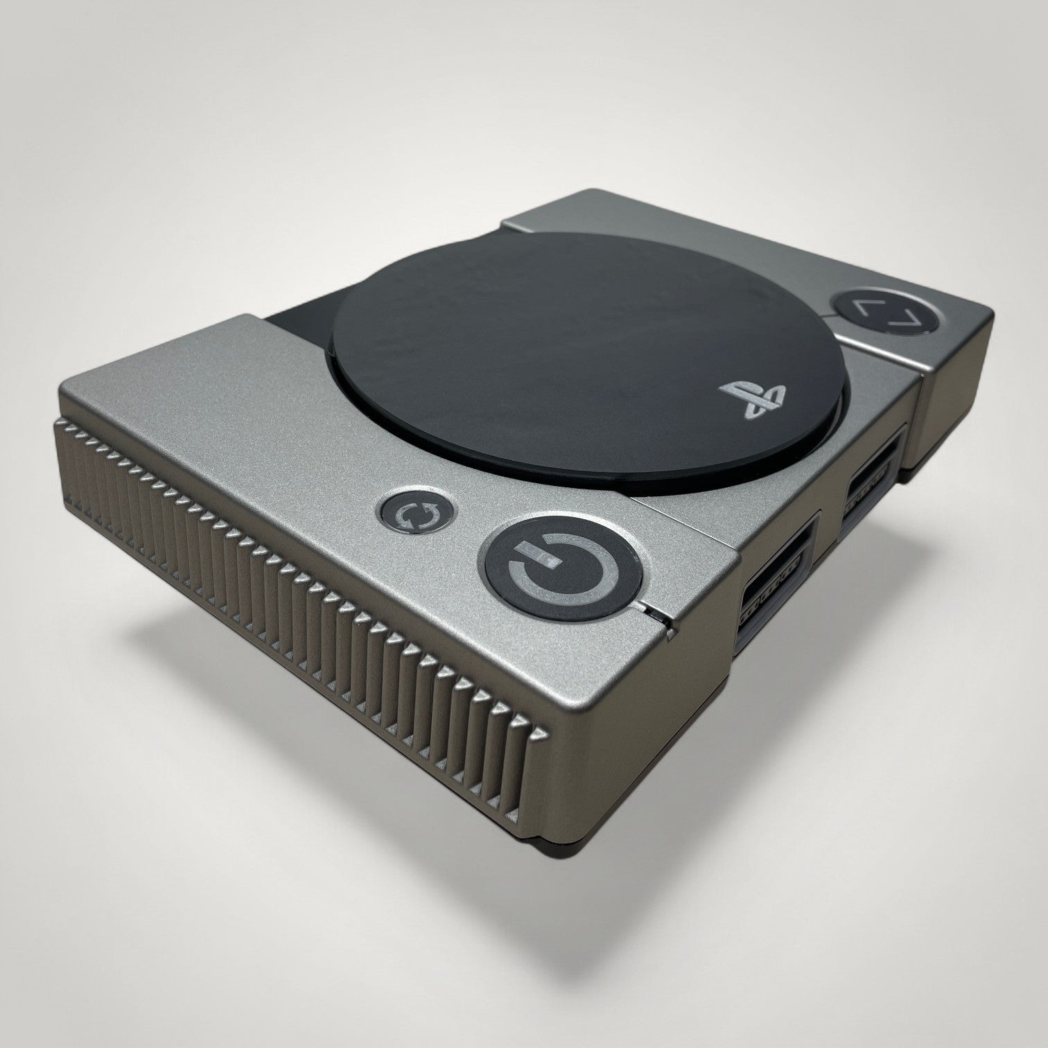 StudioFR custom black and grey PlayStation 1 console with engraved logo and buttons, RGB lighting.