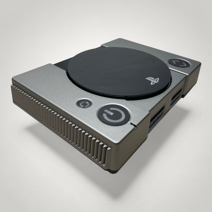 StudioFR custom black and grey PlayStation 1 console with engraved logo and buttons, RGB lighting.