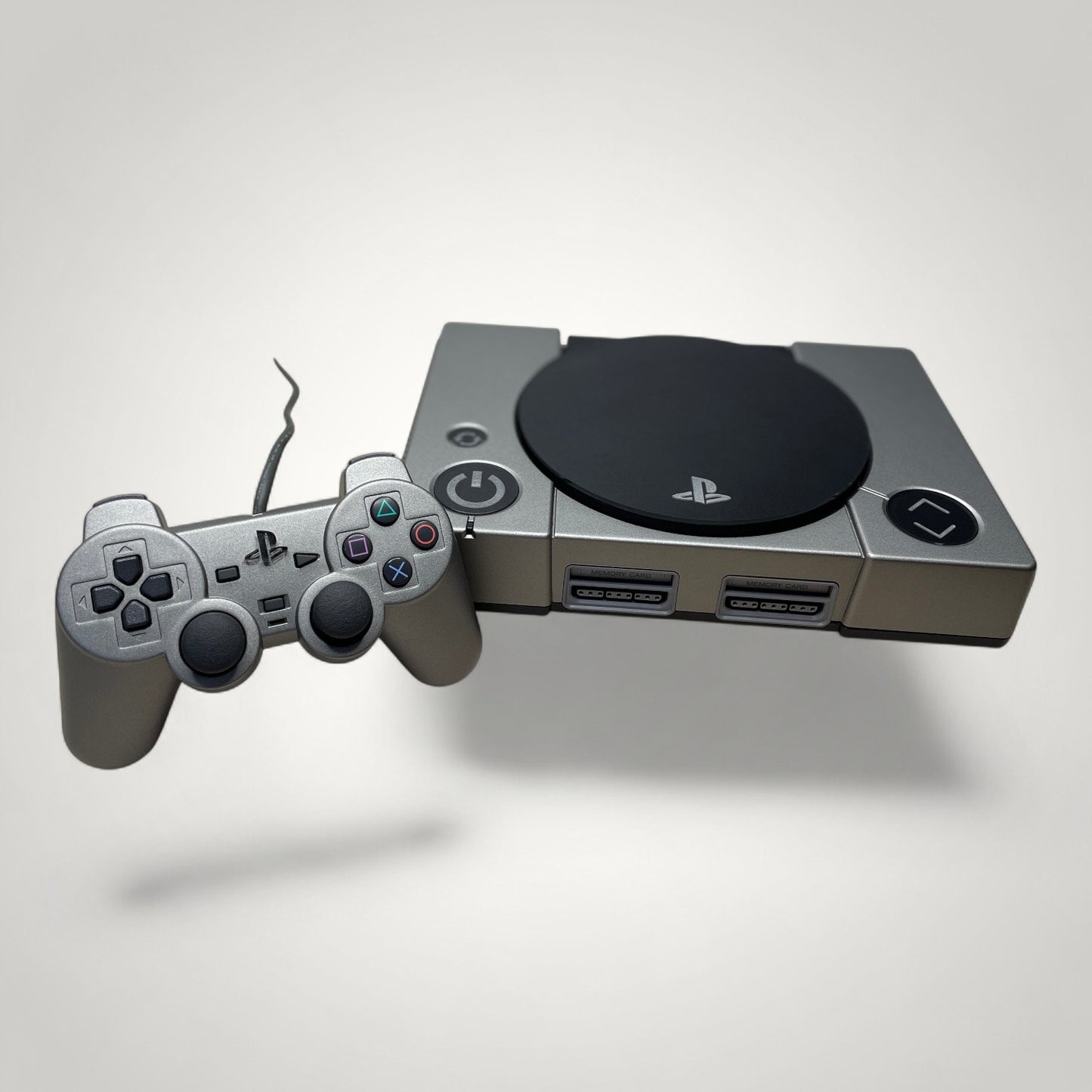 StudioFR custom black and grey PlayStation 1 console with matching controller and engraved logo.