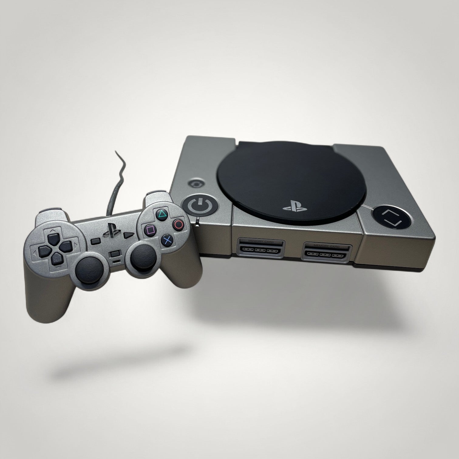 StudioFR custom black and grey PlayStation 1 console with matching controller and engraved logo.