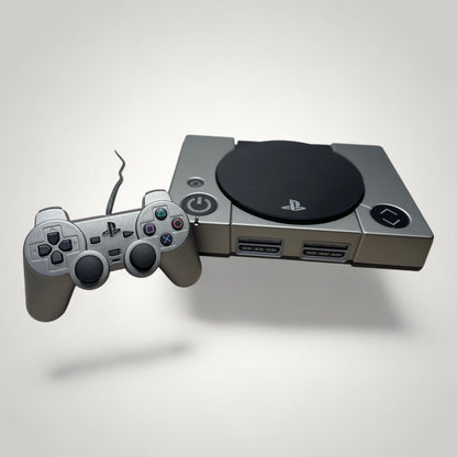StudioFR custom black and grey PlayStation 1 console with matching controller and engraved logo.