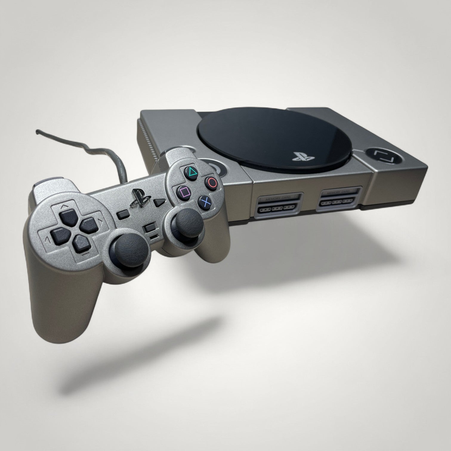 StudioFR custom black and grey PlayStation 1 console with matching controller. Features engraved logo and buttons.