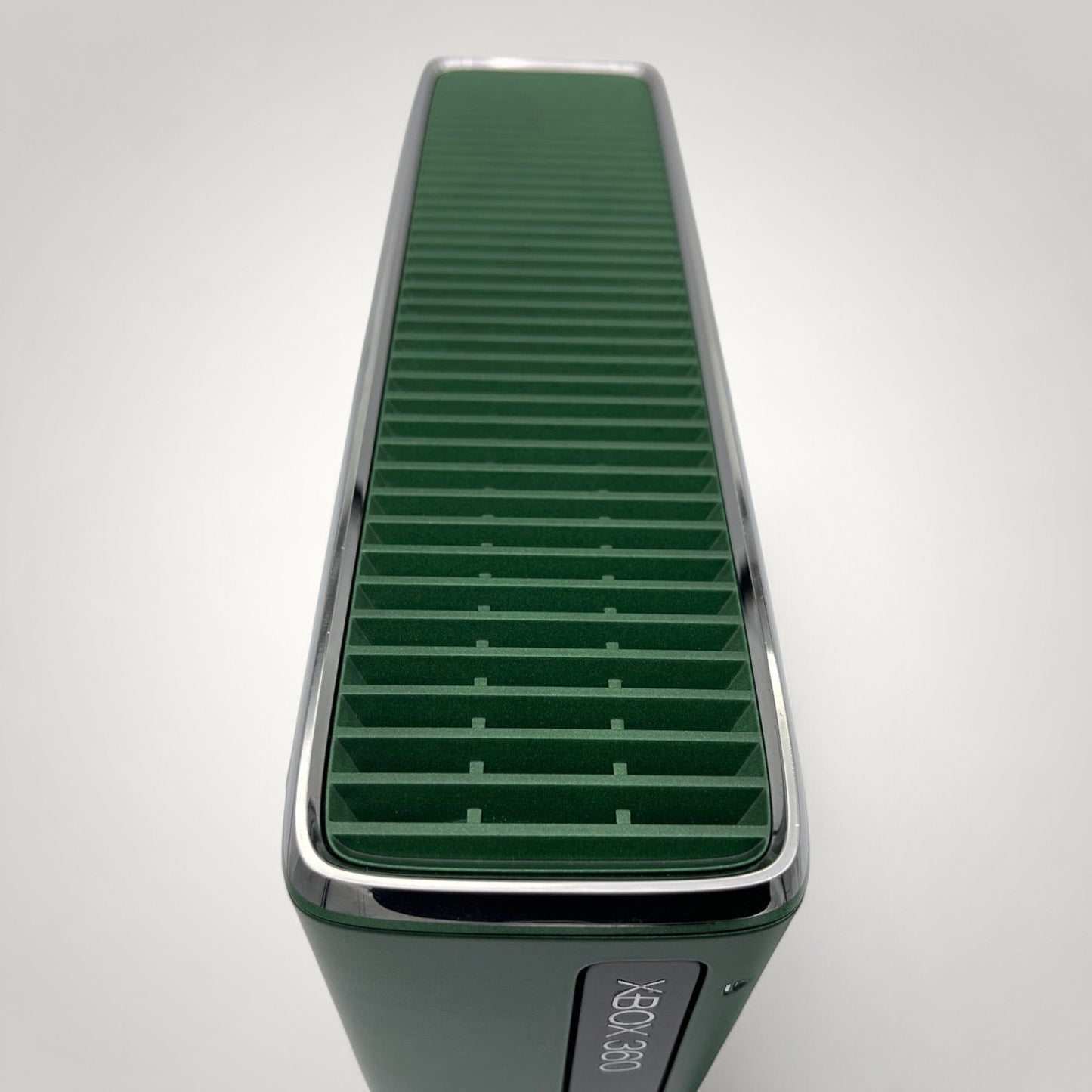 StudioFR custom black and green Xbox 360 Slim console with window mod and RGB lighting.