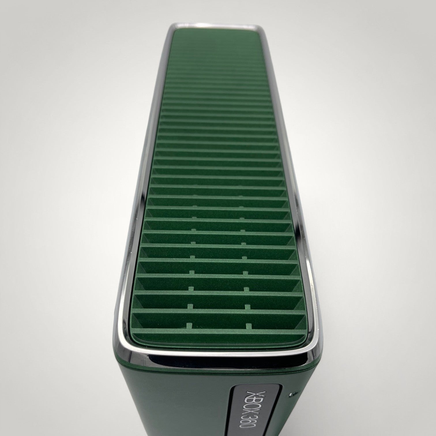 StudioFR custom black and green Xbox 360 Slim console with window mod and RGB lighting.