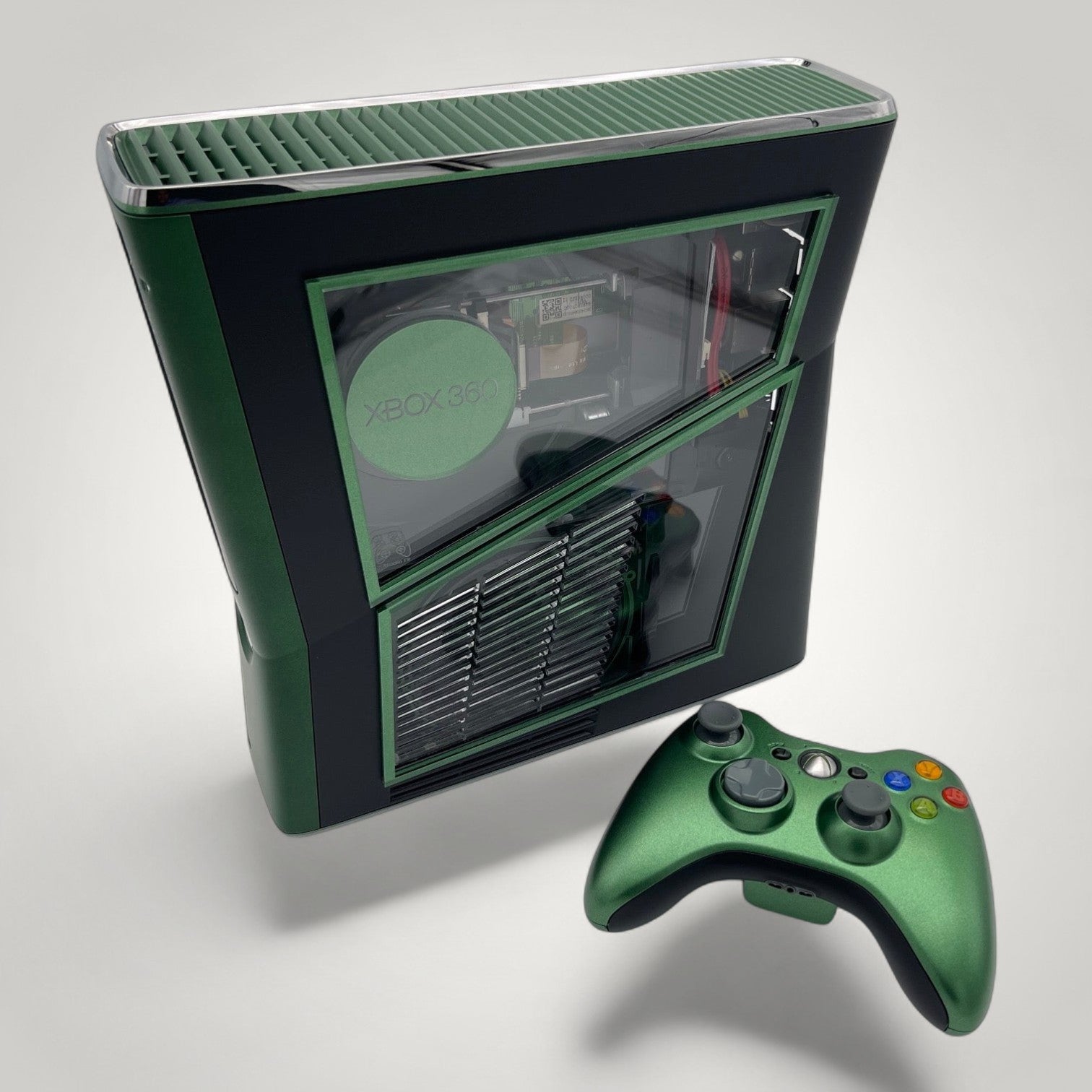 StudioFR custom black and green Xbox 360 Slim console with window mod and matching controller.