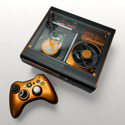 StudioFR customized Xbox 360E console in black and copper with a clear top window showing internal components and RGB lighting. Includes matching copper controller.