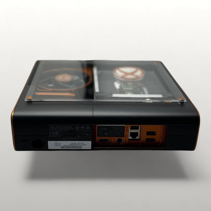 StudioFR customized black and copper Xbox 360E console with clear top window showing internal components and RGB lighting.
