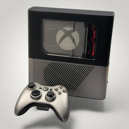 StudioFR custom black and grey Xbox 360E console with window mod and matching controller. RGB lighting visible.