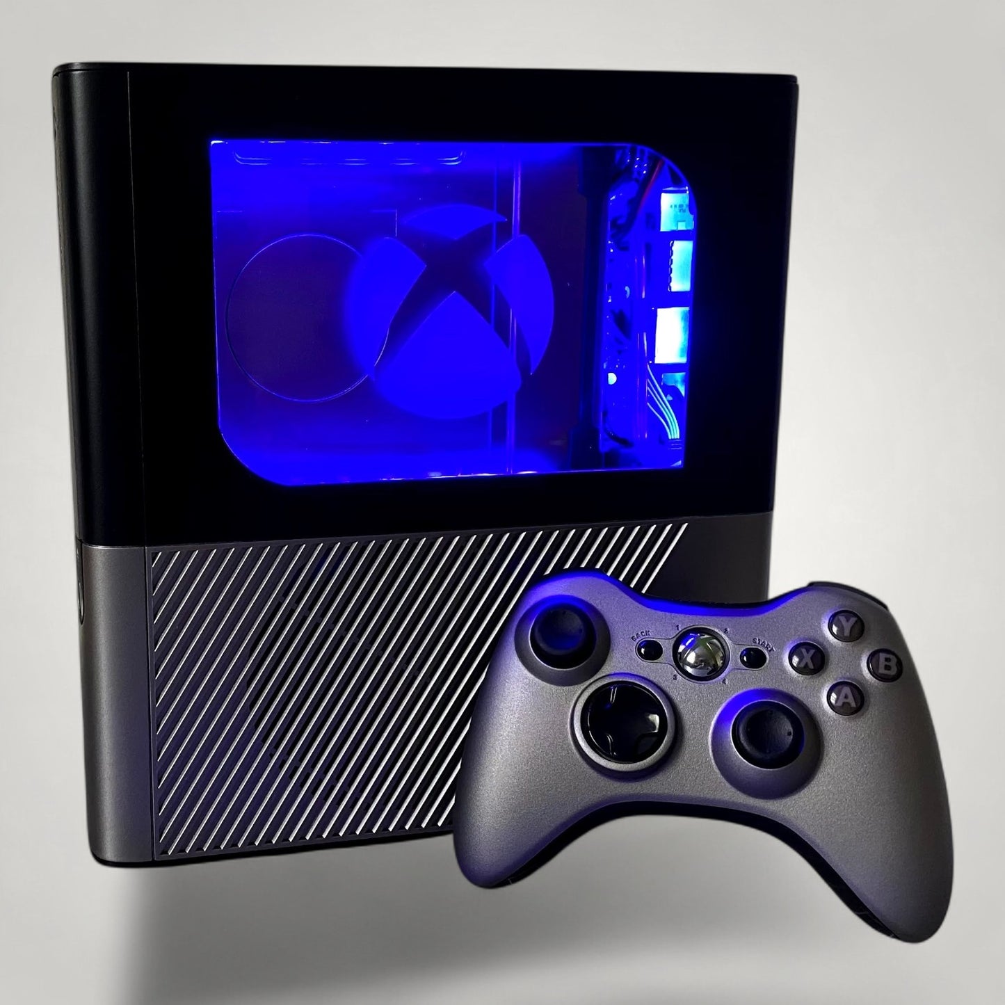 StudioFR custom black and grey Xbox 360E console with RGB lighting and matching controller.