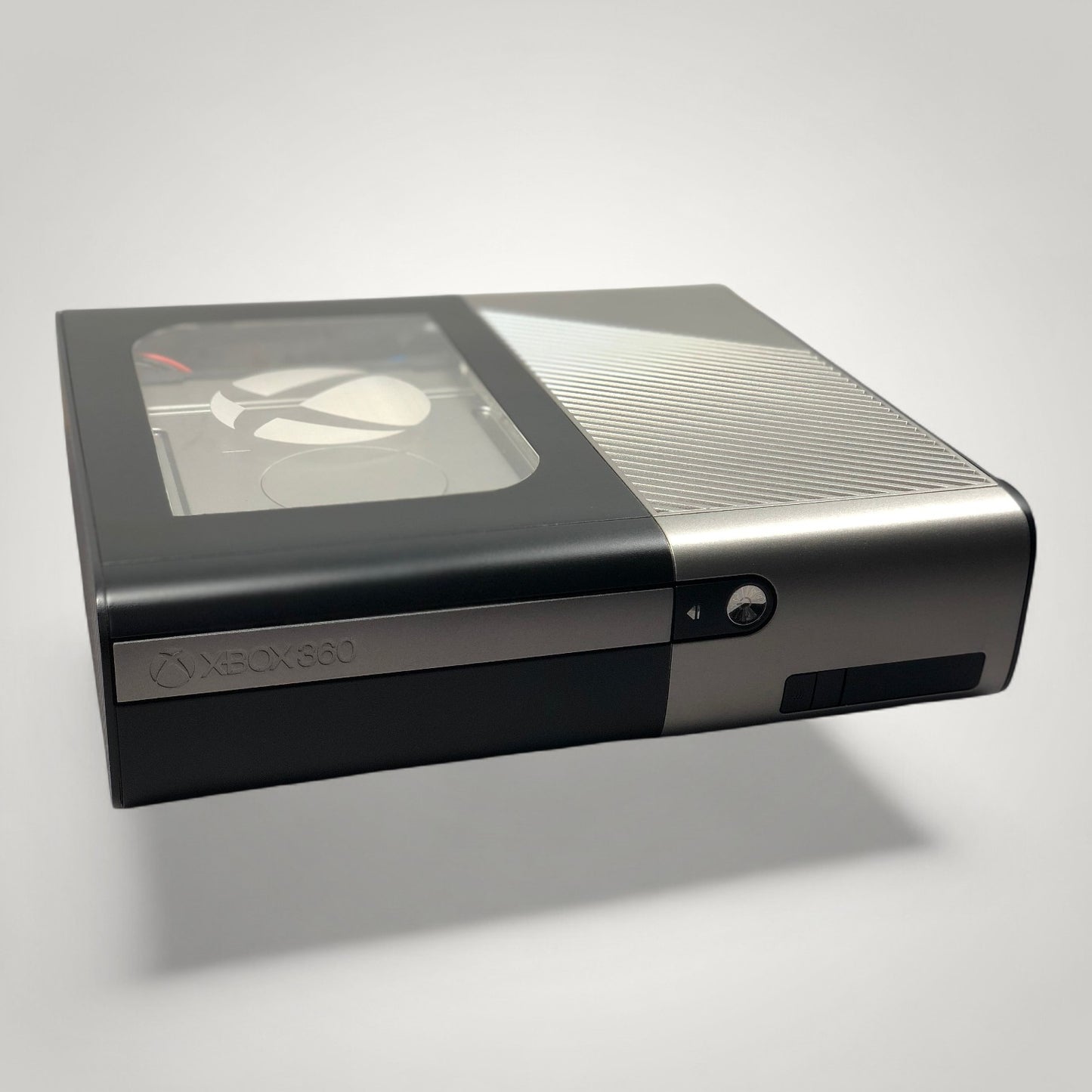 StudioFR custom black and grey Xbox 360E console with window mod and RGB lighting. One-of-one build.