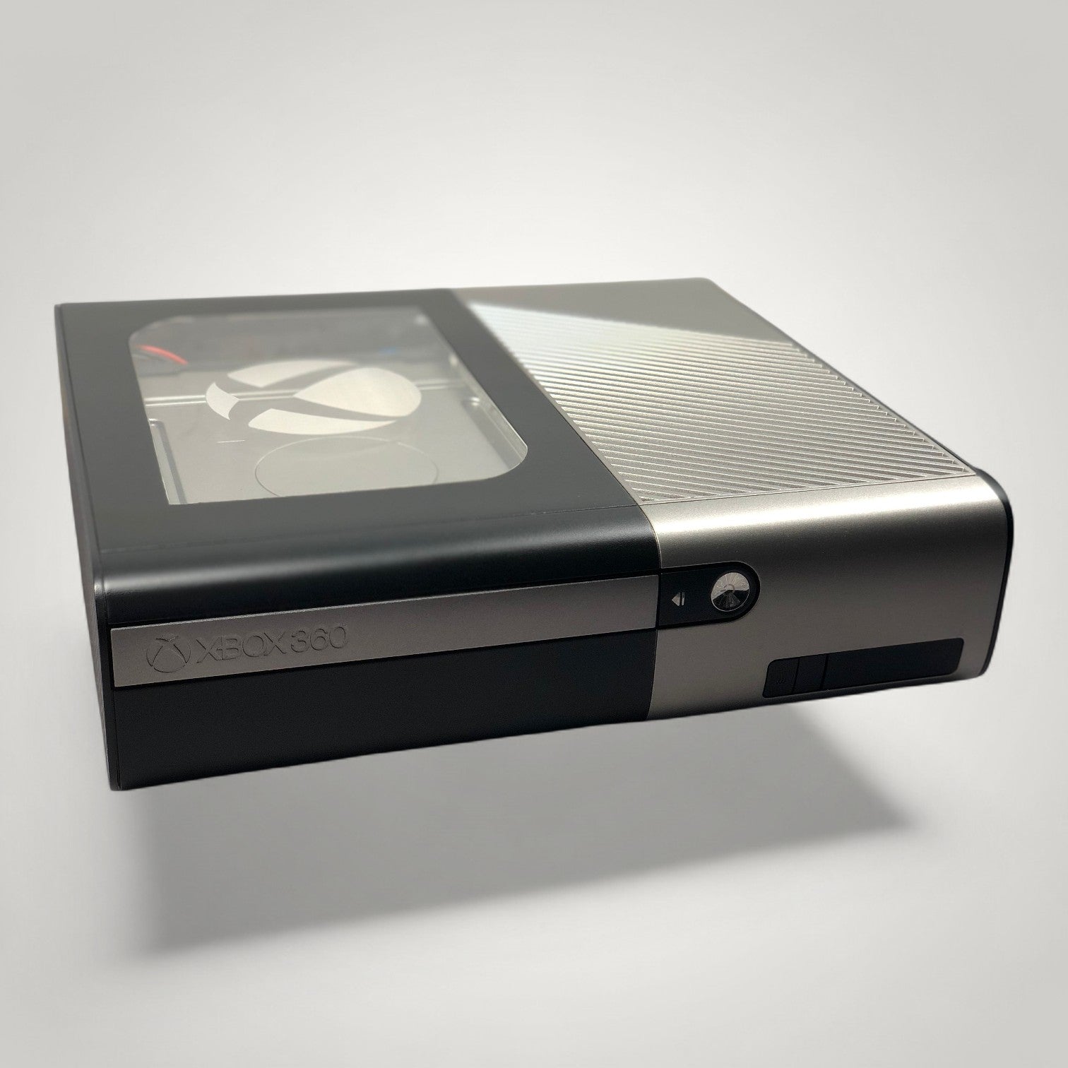 StudioFR custom black and grey Xbox 360E console with window mod and RGB lighting. One-of-one build.