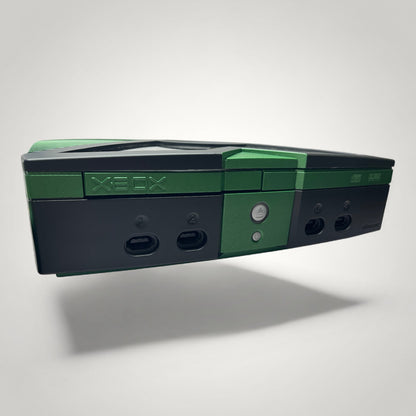 StudioFR custom black and green Xbox Original console with HDD mod and RGB lighting visible through a window mod.