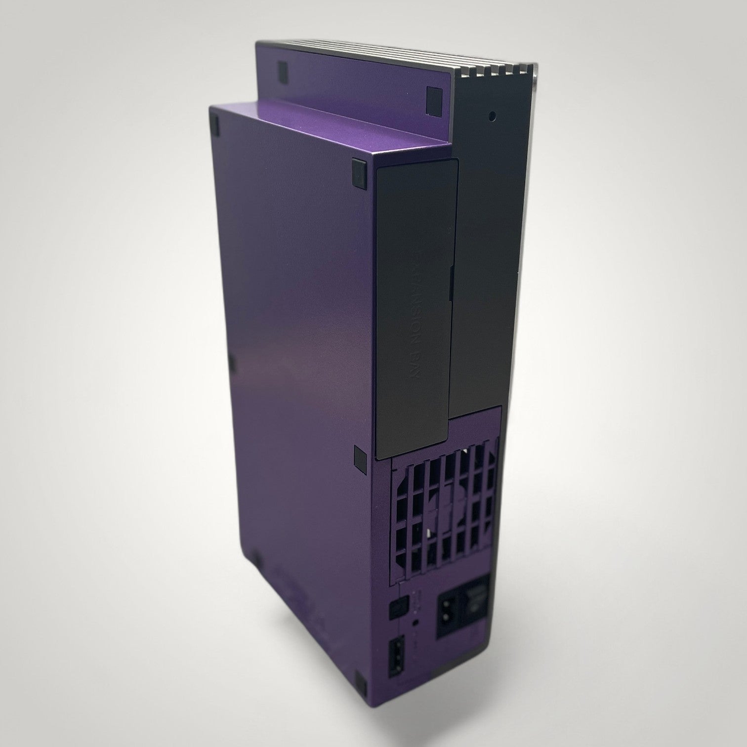 StudioFR customized purple and grey PlayStation 2 Fat console with engraved logos and RGB lighting.
