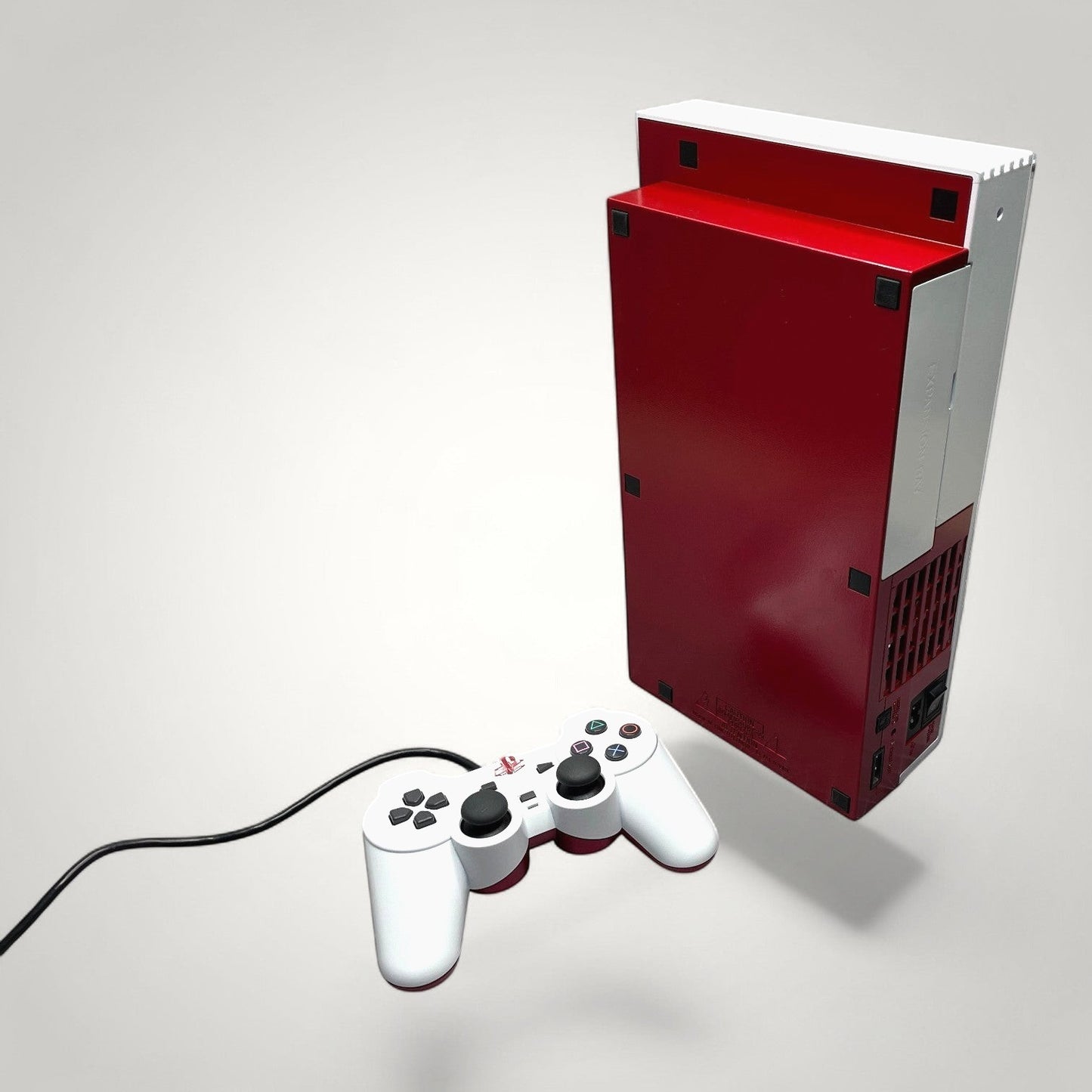 StudioFR customized red and white PlayStation 2 Fat console with matching controller.